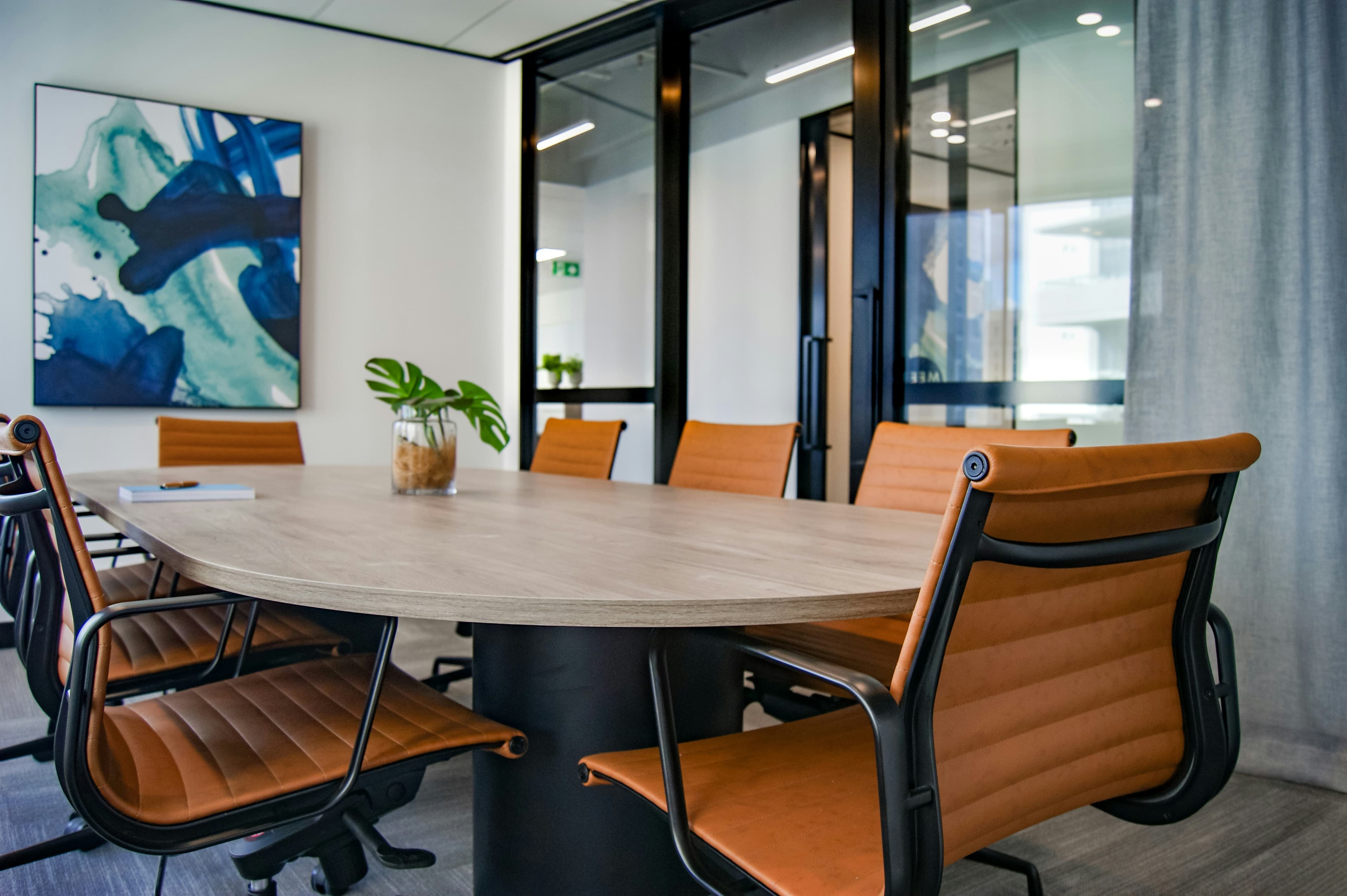 Modern conference table with ergonomic leather chairs