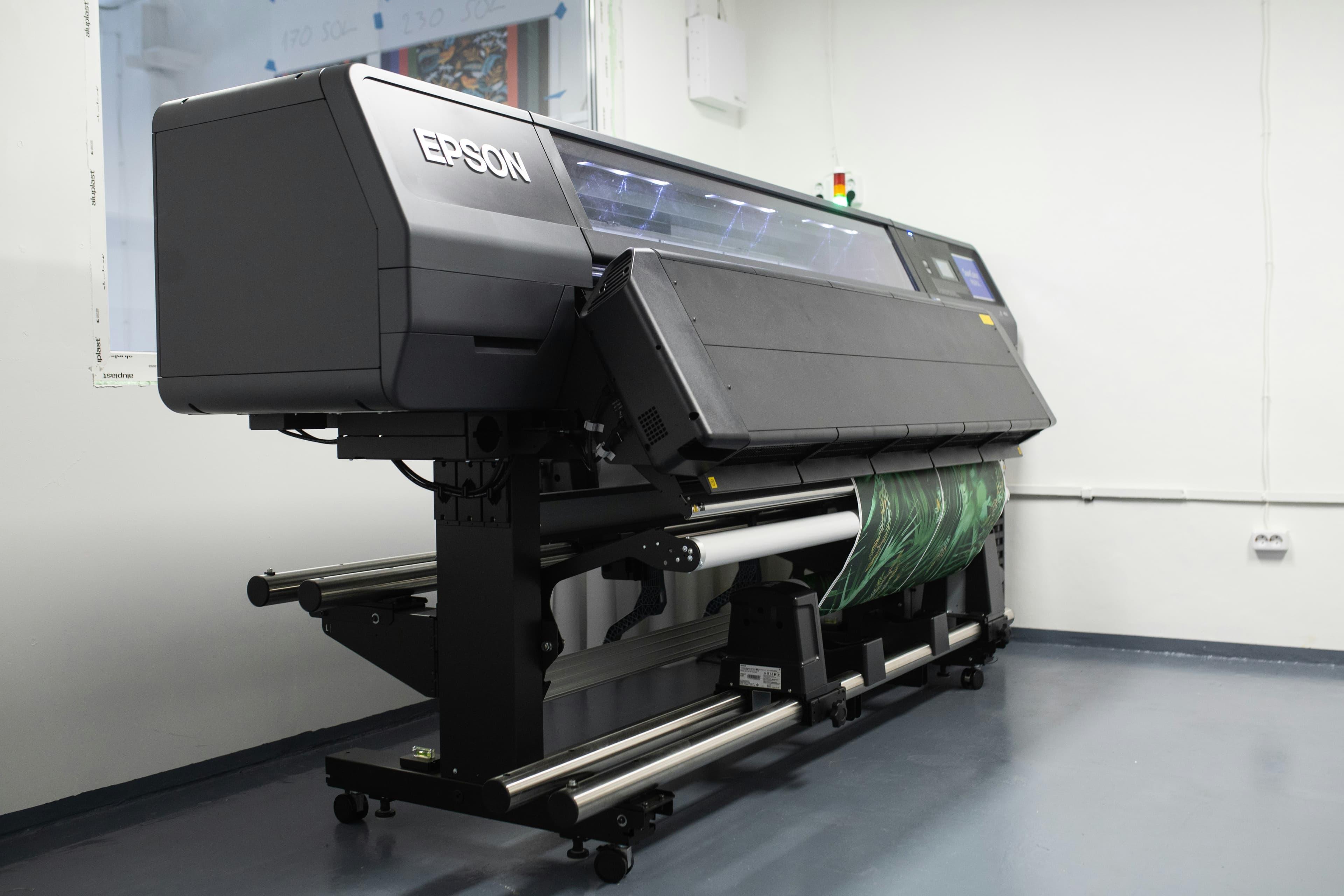 Large-format office printer in a professional workspace